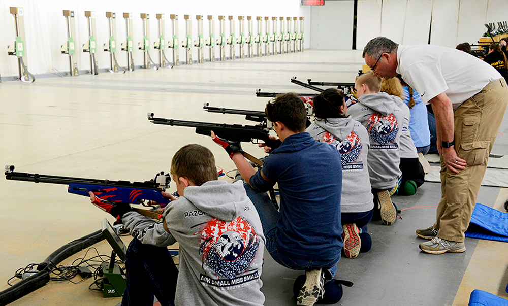 youth shooting group at range