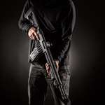 man holding a shotgun